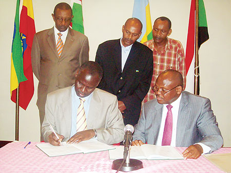 Stanislas Kamanzi signing the agreement yesterday. Seated with him is Ugandau2019s Regional Coperation Minister, Isaac Musumba while Rwandau2019s envoy to Uganda, Frank Mugambage (L) looks on. (Photo G. Muramila)