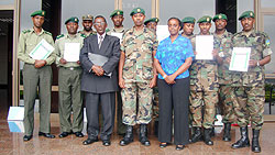 Successful candidates pose with military spokeman, Jill Rutaremara and COSTA Joshua Mbaraga.