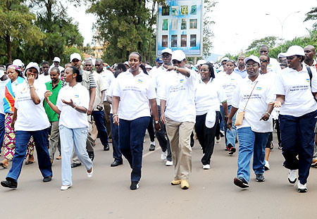 Senate President, Vincent Biruta, talks to First Lady, Jeannette Kagame, as they lead the march from Parliament to the national stadium Remera. (Photo/ J. Mbanda)