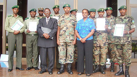 Successful candidates pose with military spokeman, Jill Rutaremara and COSTA Managing Director, Joshua Mbaraga