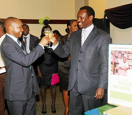 Maurice K. Toroitich, the managing Director KCB Rwanda. celebrates with PSF board Chairman. Robert Bayigamba, yesterday. (Photo By F. Goodman)