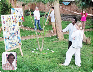 Jean Bosco Bakunzi shows off a painting in the Uburanga Art Studio gardens.