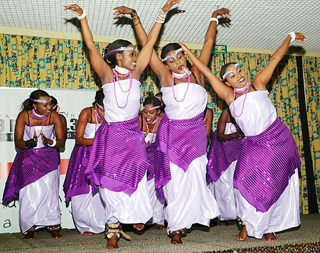 Inganzo Ngali queen dancers show their dance moves as they throw their arms in the air.