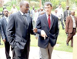 Local Government Minister James Musoni (L) chats with Global Integrity Managing Director Nathaniel Heller on Tuesday. (Photo / J. Mbanda)