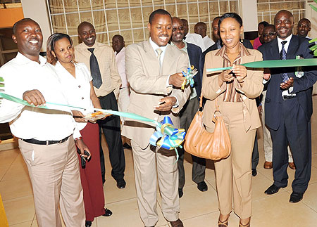 Deputy Commissioner General of Rwanda Revenue Authority Eugene Torero (C) with Molly Rugambwa of the Private Sector Federation opening the RRA Nyabugogo Branch. (Photo / J. Mbanda)