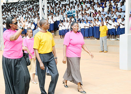 First Lady, Jeannette Kagame waves to School Children as she arrives at Nyamirambo Stadium for the awarding ceremony along with the state Minister for primary and secondary education, and KCC Executive Secretary, yesterday. (Photo J. Mbanda)