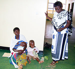 Gicumbi district human resources officer Liberata  Niyonsaba listening to Claudine Uwizeyeu2019s ordeal at the district last Friday. Photo A.Gahene