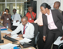 RDBu2019s COO Clare Akamanzi look on as Yves Sangano, the Director of Business Registration explains how the system works (Photo; F. Goodman)