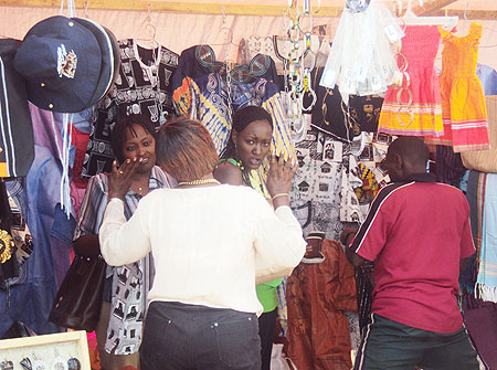 A Kenyan exhibitor gestures to potential buyers at the  expo. (Photo, D. Sabiiti)