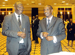The outgoing WHO Country Representative, Dr. Jack Abdoulie (L) chats with the Minister of Health, Dr. Richard Sezibera (R) during the farewell ceremony