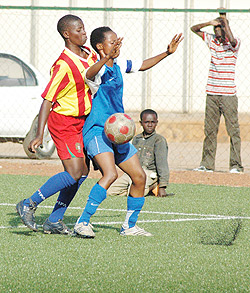 AS Kigaliu2019s Saida Ntagishimana shields the ball from a Remera Rukoma player. AS Kigali won the game 4-2 to retain the league title. (Photo: F. Goodman)