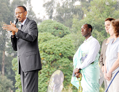 President Kagame addresses the crowd during the Kwita Izina ceremony in Kinigi yesterday. Behind him is American movie star, Don Cheadle (Photo: J. Mbanda)