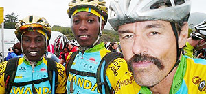 Team Rwanda cyclists pose for a photo with team coach Jonathan Boyer.