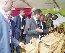 Gov Fidele Ndayisaba (in spectacles) inspects works displayed in a mini-expo held at the sidelines of Taxpayers Day celebration. Photo P Ntambara