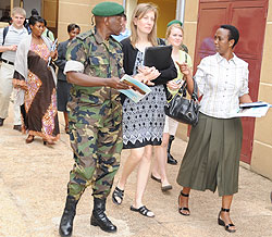 Lt. Col. Ryan listens to Senator Aloysia Inyumba at the end of their meeting at Parliament yesterday (Photo;F.Goodman)