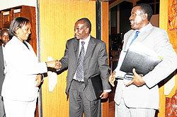 Dr. Richard Sezibera (C) shaking hands with the Speaker Rose Mukantabana while Deputy Speaker J. Damascene Ntawukuliryayo looks on after yesterdayu2019s session. (Photo; J. Mbanda)