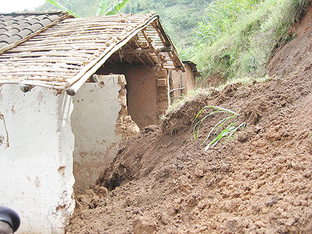 A house which was crushed by the surging land slide killing three people. 