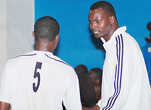 Paul Bitok passes on some tips to an APR player during a past competition.