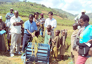 Coribaru-cooperative chairman, Jean Bosco Ntawizihirwa demonstrating the efficasy of  the rice thresher. (Photo: D. Sabiiti)