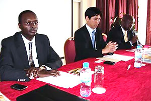 Emmanuel Hategeka, the Permanent Secretary, MINICOM listens to OVOP presentations. Next to him is Hironobu Murakami, the OVOP Team Leader. (Photo by Ivan Mugisha)