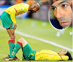 Cameroon captain tries to raise Benoit Assou-Ekottou2019s spirits after the Indomitable lions slip to an unlikely defeat against Japan. Inset is Paul Le Guen