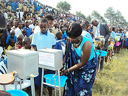 Dr. Jeanne du2019Arc Mujawamariya using a hand-washing tool during the celebrations (Photo; D. Sabiiti)