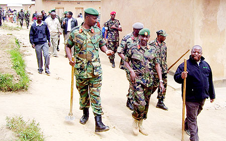 The Governor of the Northern Province, Aimu00e9 Bosenibamwe (R), and the RDF Chief of Defence Staff, Lt. Gen Charles Kayonga (L) and other senior officers, taking part in community development activities in Gicumbi district yesterday. This was part of the ong
