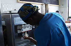 A worker at Inzozi Nziza ice cream parlor makes ice cream in Butare, Rwanda.
