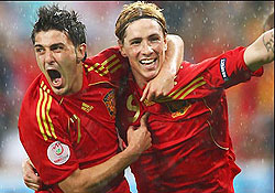 David Villa celebrates with Fernando Torres. Villa scored a brace to put Spain back on track. (Net Photo)