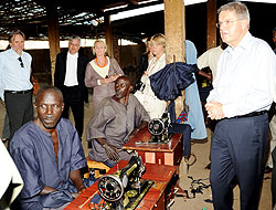 Dutch Minister, Ernst Hirsch Ballin (R), during his visit to a TIG tailoring workshop in Bugesera District yesterday (Photo; J. Mbanda)