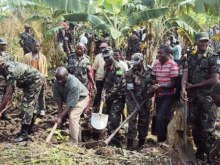 RDF soldiers joined by residents to kick start the construction of houses for the needy. (Photo; B Mukombozi)