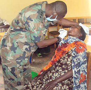 Capt. Pierre Claver Mazimpaka performing a dental operation on one patient at Nyagatare hospital yesterday (Photo / D. Ngabonziza)