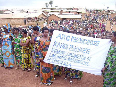 Refugee women trained in tailoring carry a placard hailing ARC initiative to promote vocational training, during celebrations to mark world Refugee Day. (Photo / A. Gahene)