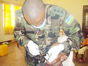 Captain Aimable Nkubito attends to a patient during the on-going RDF outreach programme  in Kayonza. (Photo: S. Rwembeho)