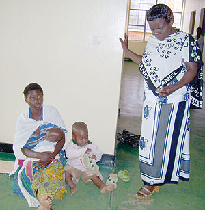 Gicumbi district Human Resources officer Liberata  Niyonsaba  listening to Uwayezu  Claudineu2019s  ordeal  at district ofiices. (File photo)
