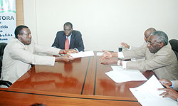 Dr Jean Damascene Ntawukuriryayo  hands in passport photos among other requirements to NEC boss Chrysologue Karangwa yesterday. (Photo F. Goodman)