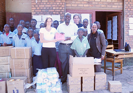 Jason Rugero, head of Nkundabana children centre with the childern recieve the donation from Esther Kronsbein, Country Coordinator HHN Rwanda. Photo G. Mugoya