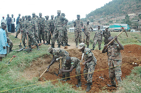 RDF members constructing the bridge at River Nyabugogo yesterday ( Photo by F. Goodman)