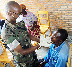 Capt. Halifa Ndayisabye works on one of the patients (photo S Nkurunziza)