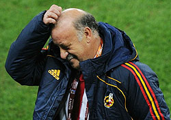Spainu2019s coach Vicente Del Bosque scratches his head during the 2010 World Cup semi-final football 