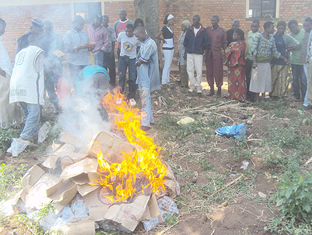 Residents of Rwamagana witnessing the burning of the alcohol. (Photo: S. Rwembeho)