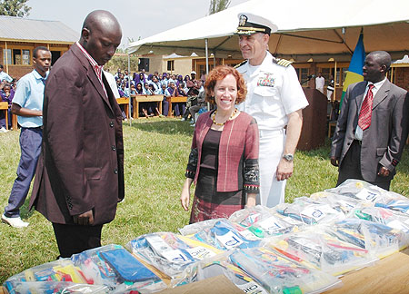 The Charge du2019 Affairs of the US Embassy, Anne Casper and Kicukiro Mayor, Jules Ndamage, inspecting the scholastic materials as Capt. Scott Vasina looks on (Photo: F. Goodman)