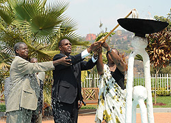 Protais Mitali, Aisa Kirabo and IBUKA president Theodore Simburudali putting out the flame of hope at Kigali Memorial Centre yesterday (Photo; F. Goodman)