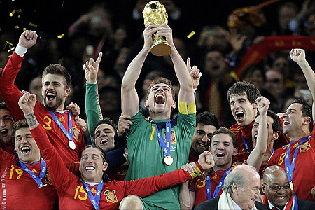 Spain captain Casillas holds the World Cup trophy aloft as ticker tape falls at Soccer City.