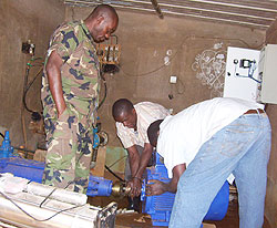 RDF 408 Brigade technicians working on a water pump at Kigarama water source (Photo; A.Gahene)