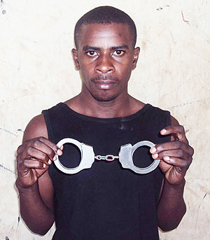 NABBED; Nshimiyimana Pascal displaying the handcuffs (Photo; B. Mukombozi)
