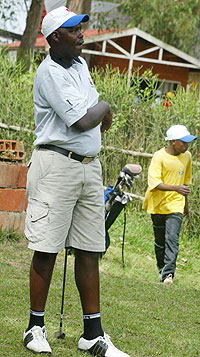 Rutamu admires one of his shots at the Kigali Golf Course.