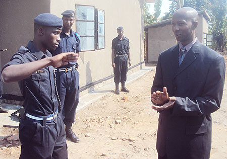 PC Abdoulkalim Kazoba salutes Minister Harerimana after he officially handed over the house to him. (Photo: S. Rwembeho)