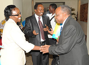 NURC Chairman Bishop John Rucyahana greets Liberal Partyu2019s Odette Nyiramirimo as Executive Secretary Jean Baptiste Habyarimana  (C) looks on. (Photo J Mbanda)