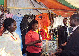 Dr. Mathias Harebamungu shares a light moment with Kenyan exposants during his tour at the PSF Mini expo in Muhanga (Photo / D.Sabiiti).